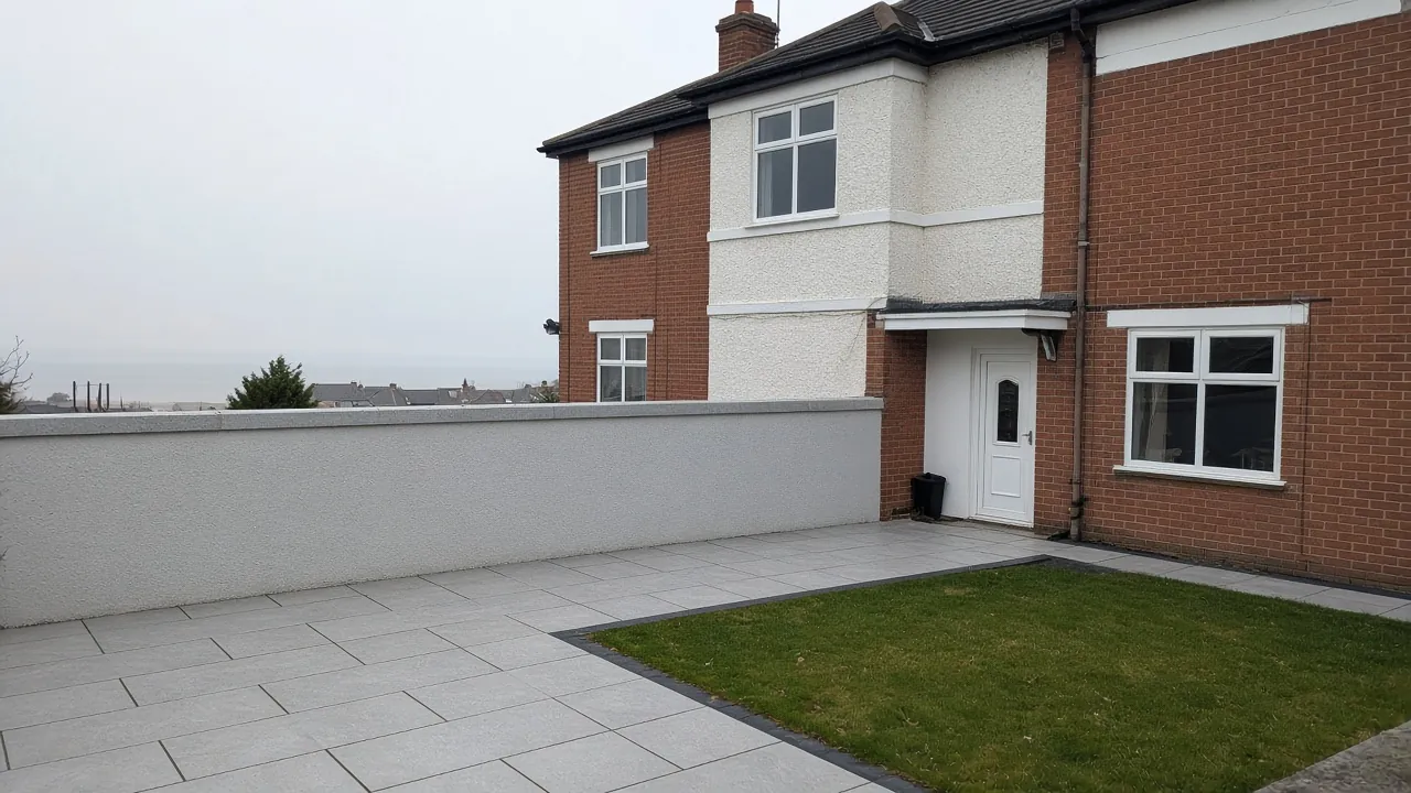 Example image: porcelain patio with a low wall behind a 1930s semi-detached house near the sea